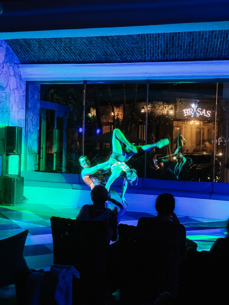 A couple doing acrobatics at a resort's live entertainment area