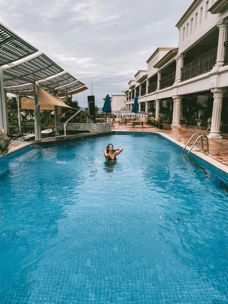 A woman in a large swimming pool 