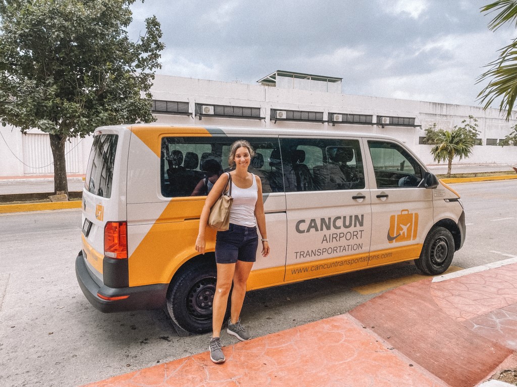 Woman standing in front of a white and yellow van inserted in a post about traveling from Cancun to Holbox