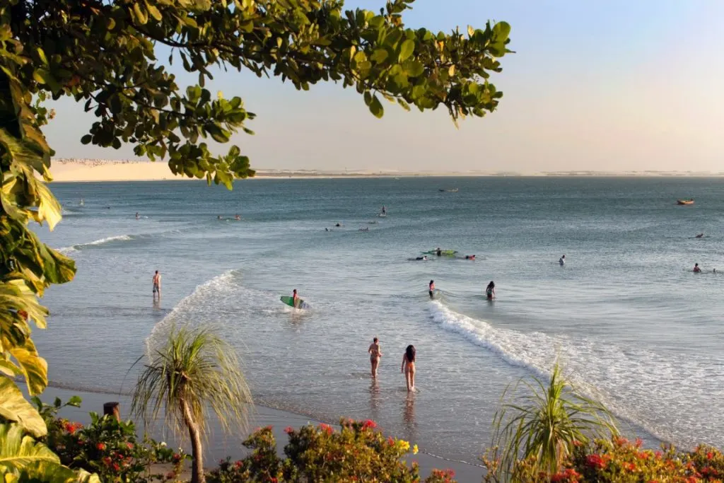 People swimming and surfing in a beach in Jericoacoara