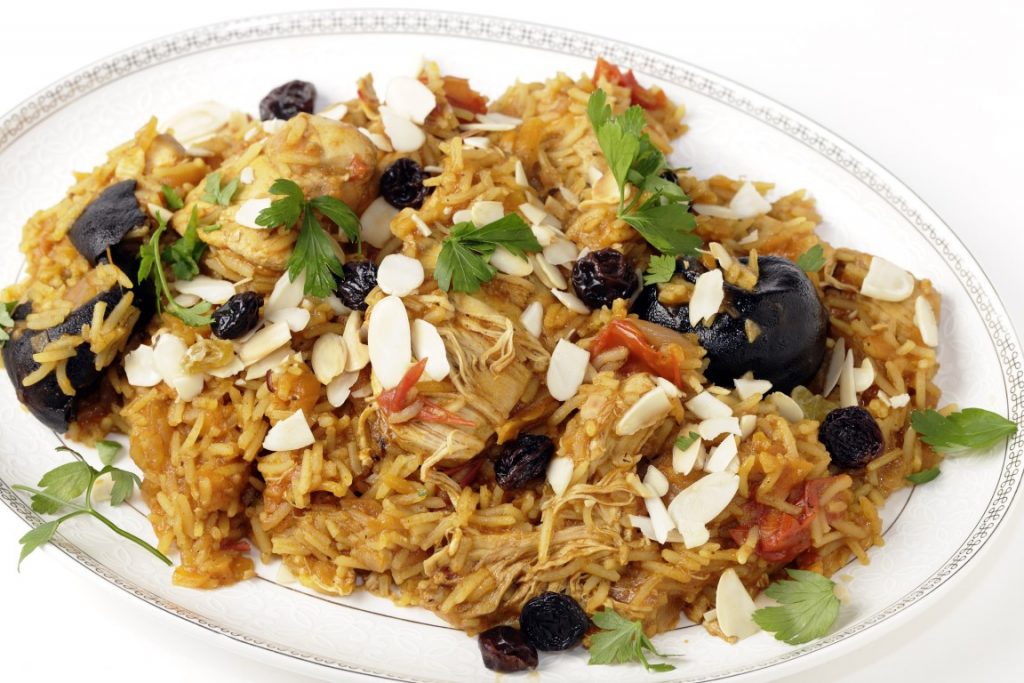 A dish of Majboos served in a white plate