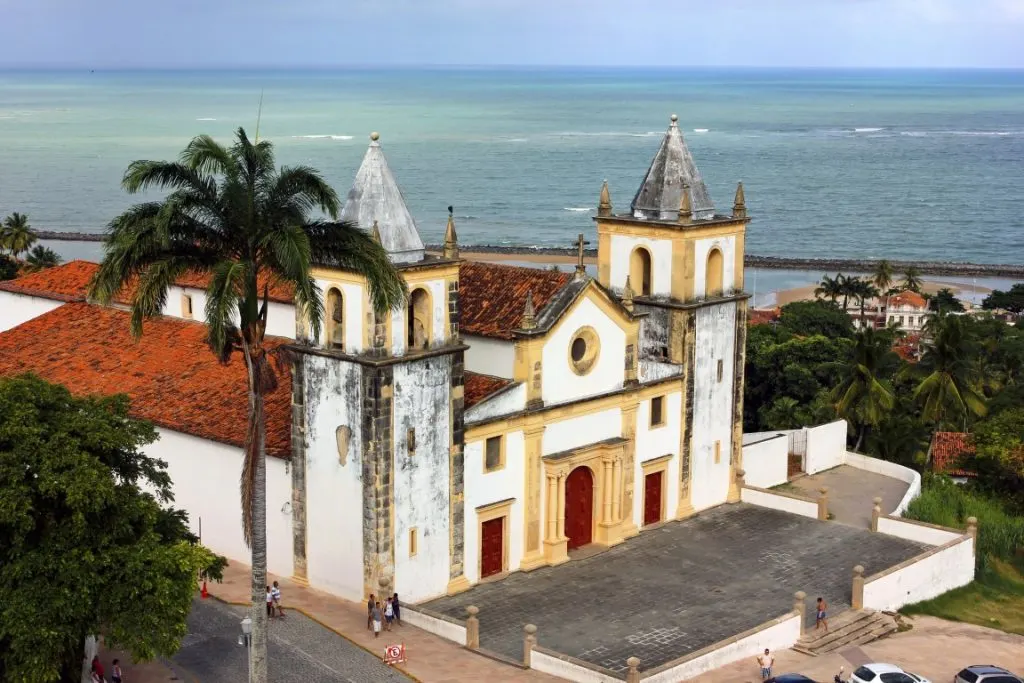 A weathered white and yellow church in  Olinda