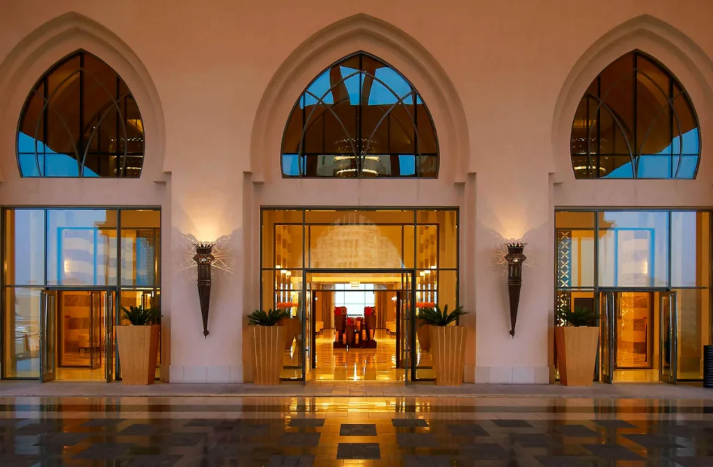 The entrance to an elegant hotel, with glass doors and polished interiors