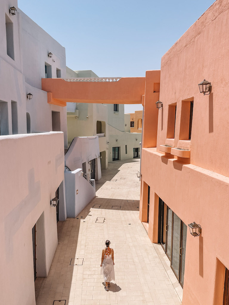 A woman walking on an alley in Old Doha Port