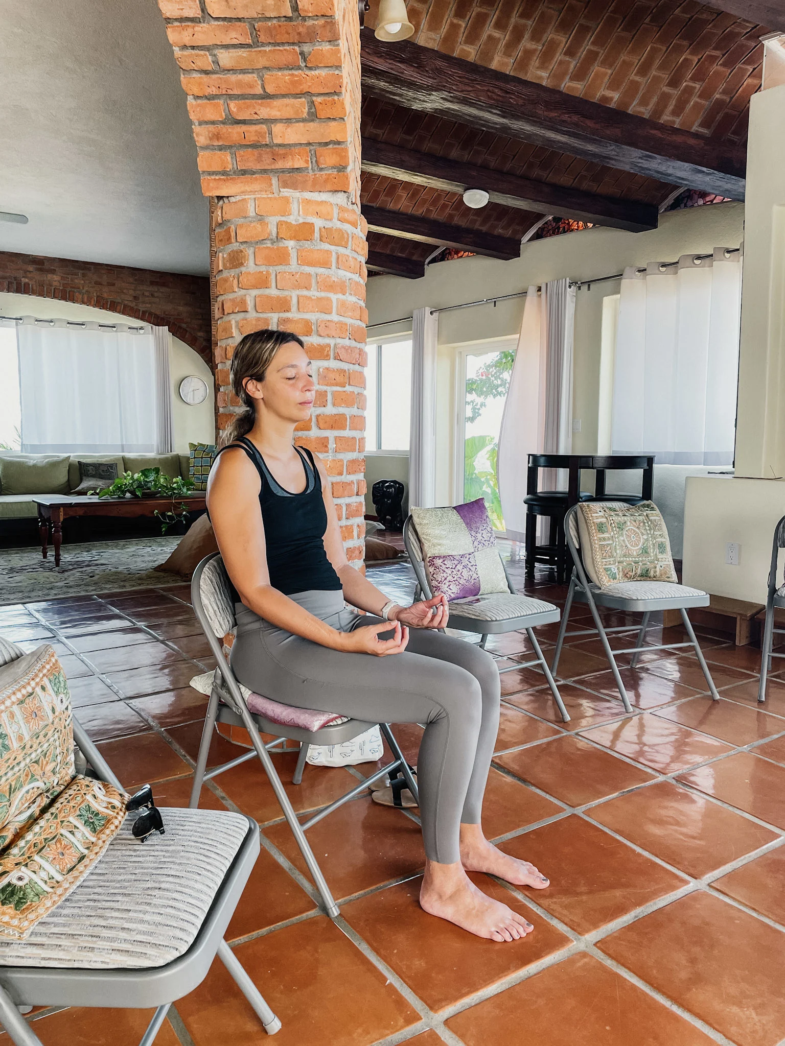 A woman sitting on a chair, meditating in San Jose del Cabo