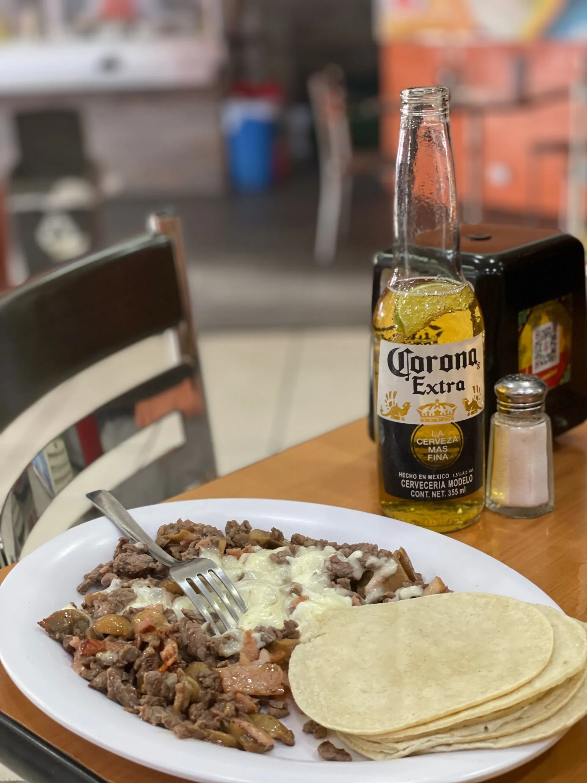 A plate with tortillas, and taco fillings on the side