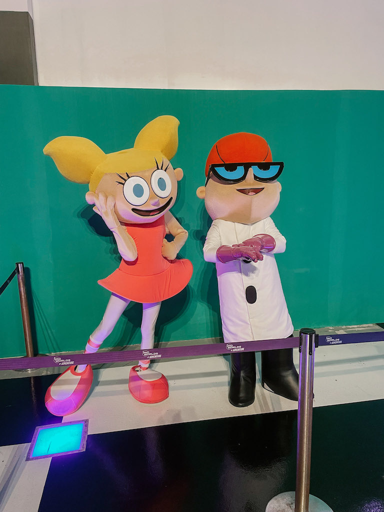 Two characters posing at a theme park