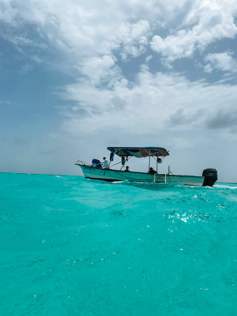 A boat sailing in the turquoise waters of Playa del Carmen