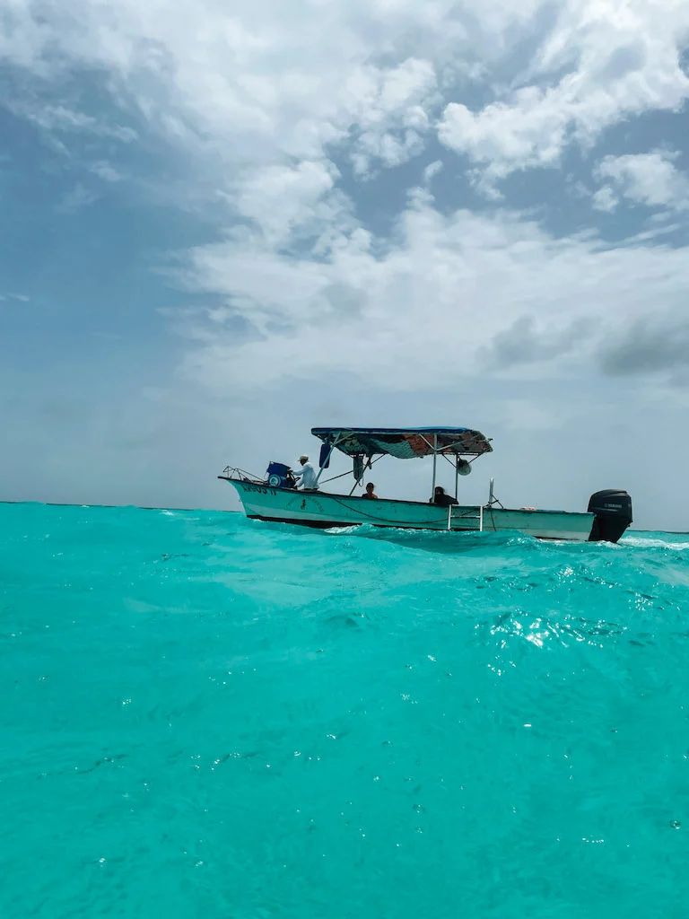 Small boat sailing over turquoise water