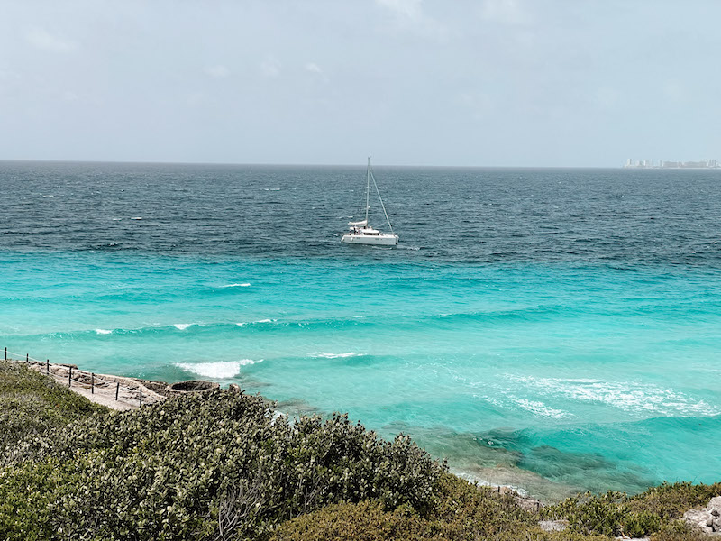 A yacht sailing in blue waters, insterted in a post about excursions in Playa del Carmen