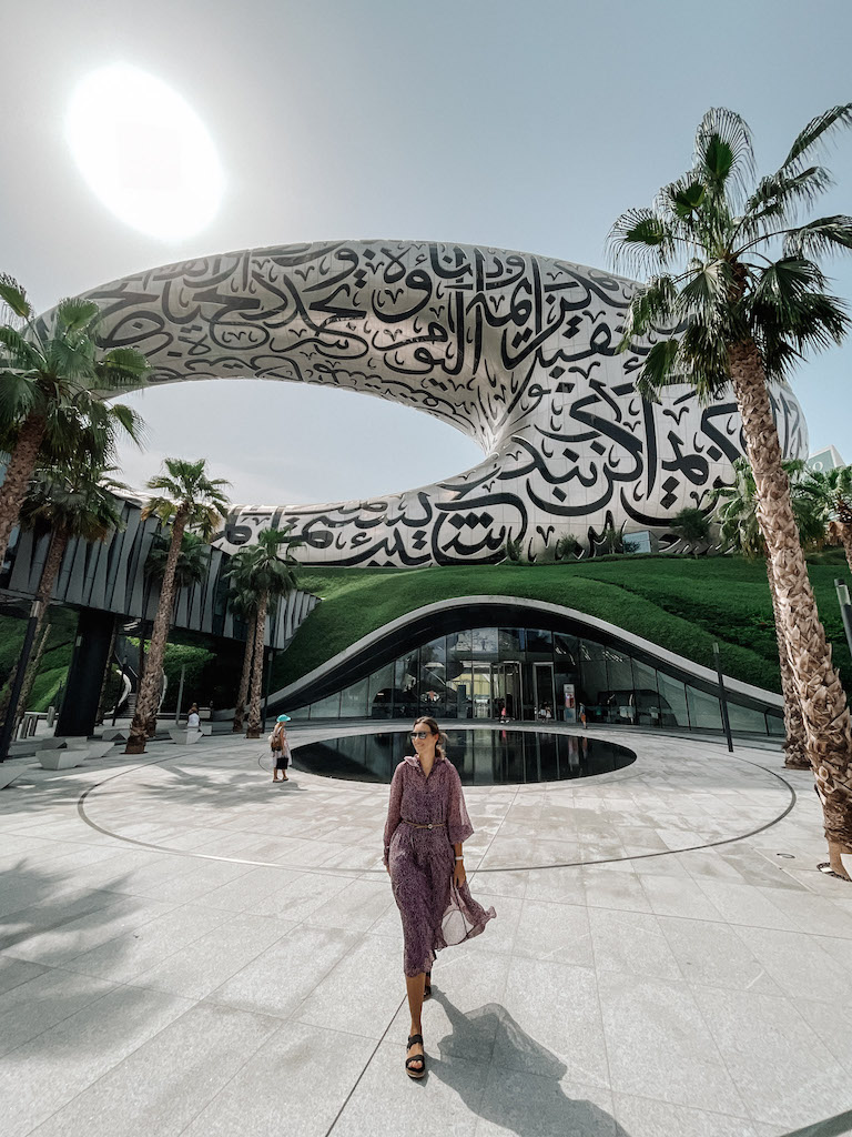 A woman walking outside the Museum of the Future building