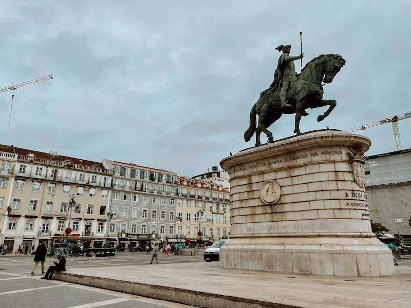 A statue of a man on a horse in a city square