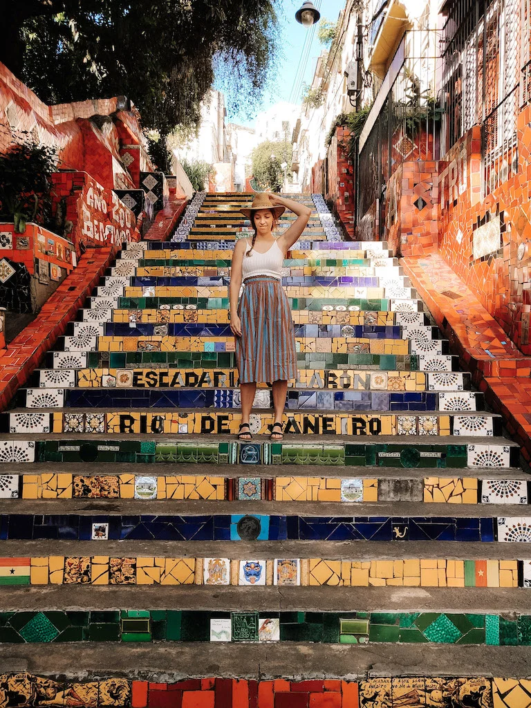 A woman standing in the colorful Selaron Steps of Rio de Janeiro