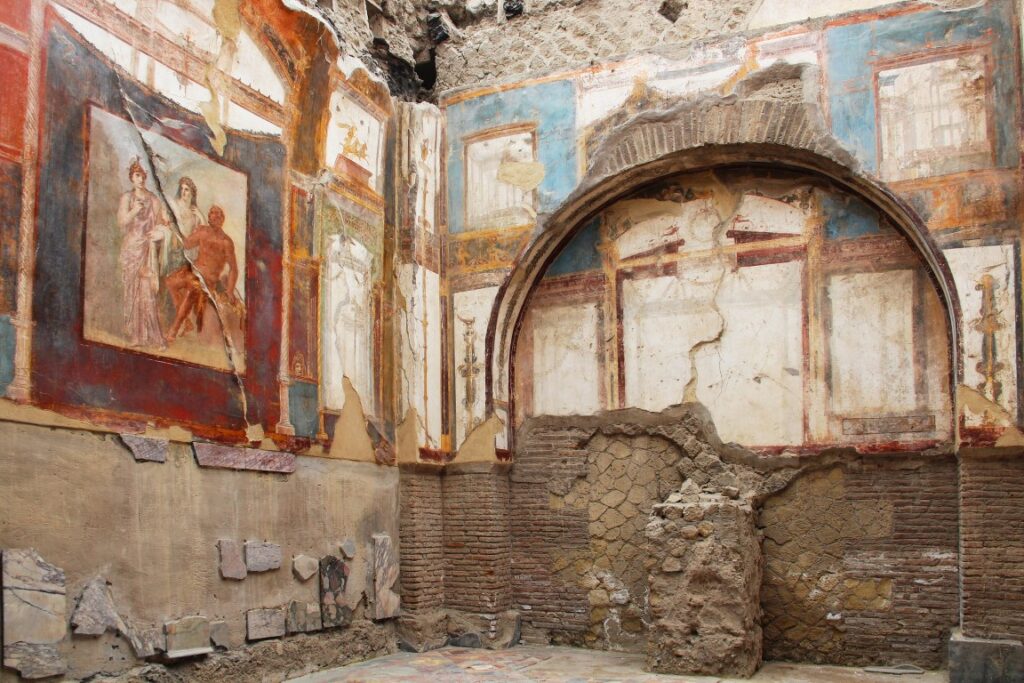 Colorful frescoes inside a building in Herculaneum, one of the greatest day trips from Naples