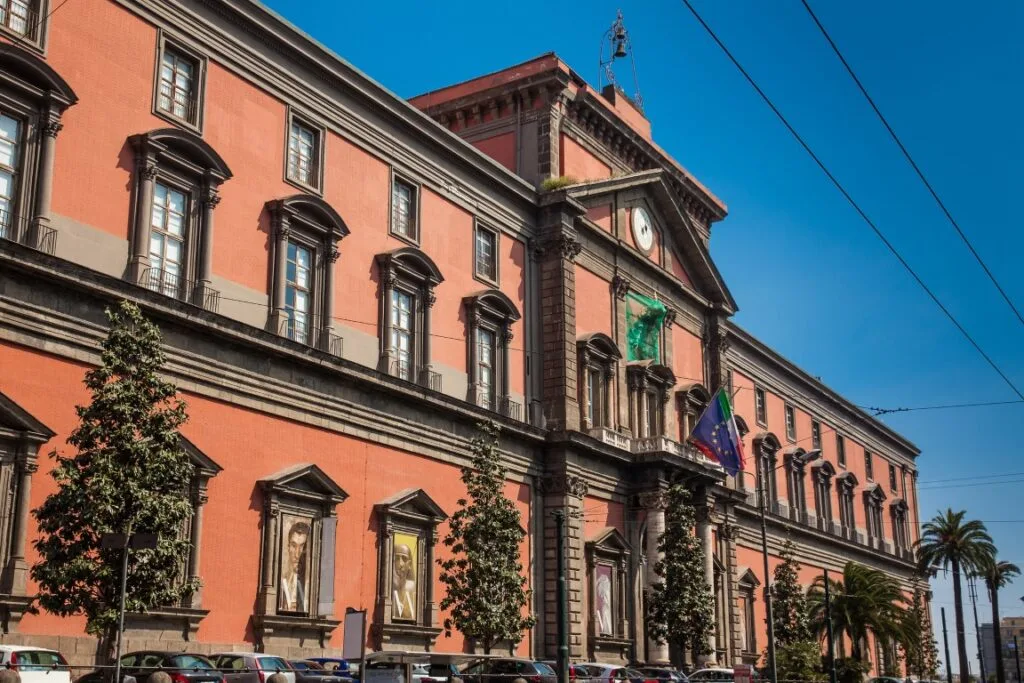 The orange facade of the National Archaeological Museum of Naples