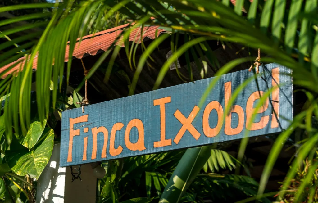 A hand-painted sign that reads Finca Ixobel in orange letters