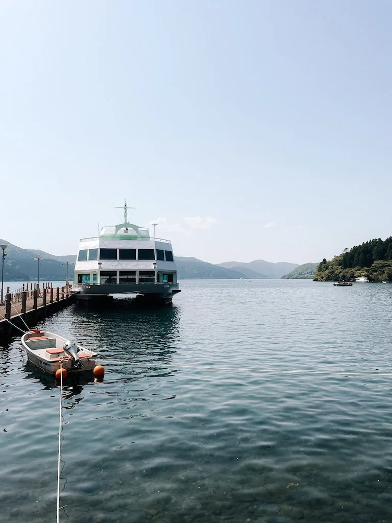 Lake Ashi in Japan, with a cruise next to a dock 