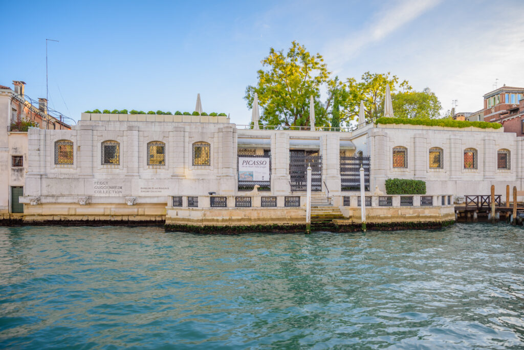 The white building of the Peggy Guggenheim Collection Museum in Venice seen from the water