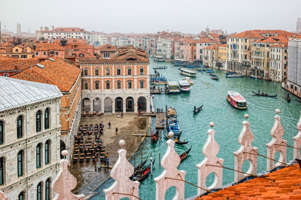 A vista of the Grand Canal and buildings in Venice, seen from  T Fondaco dei Tedeschi