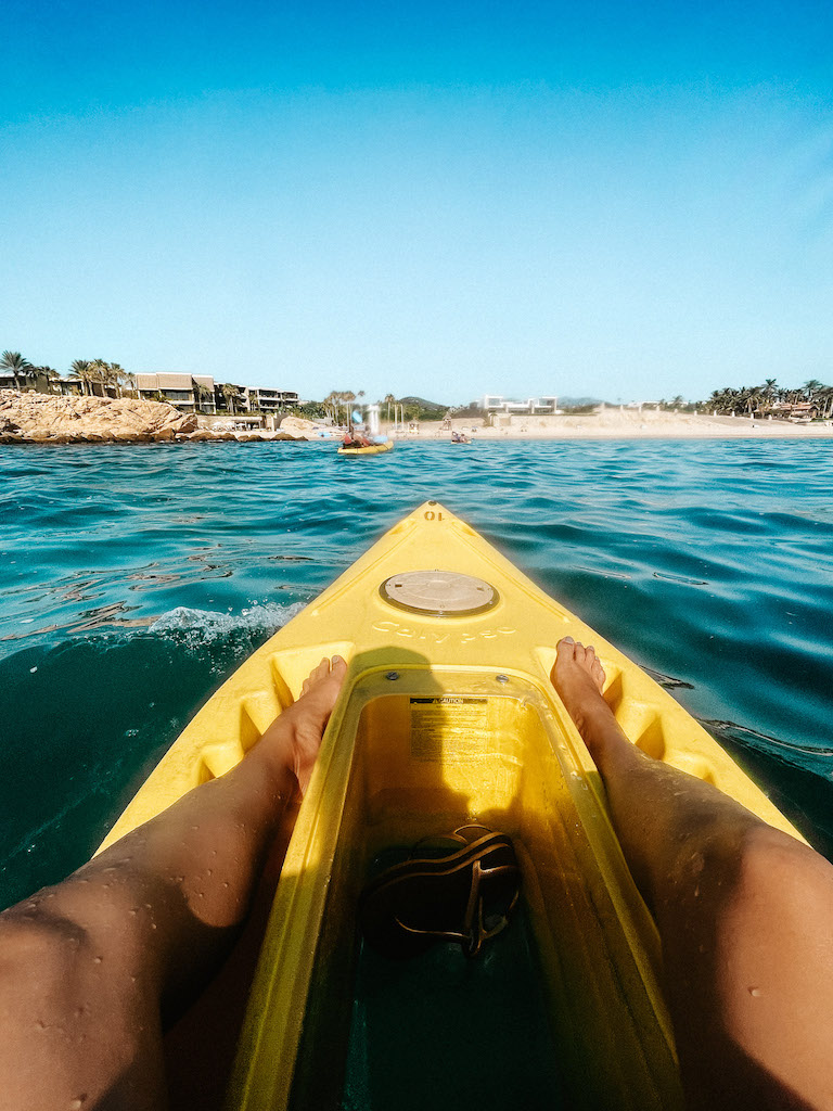 Image of a yellow kayak in front of Chileno Bay in Cabo san Lucas.