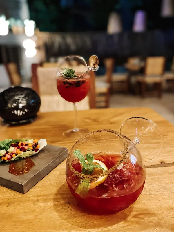 Mezcal cocktails on a wooden table.