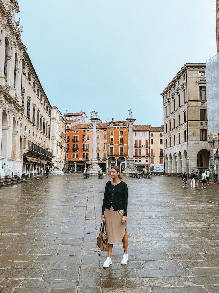 A woman walking in the historic center of Vicenza during a day trip from Padua, Italy