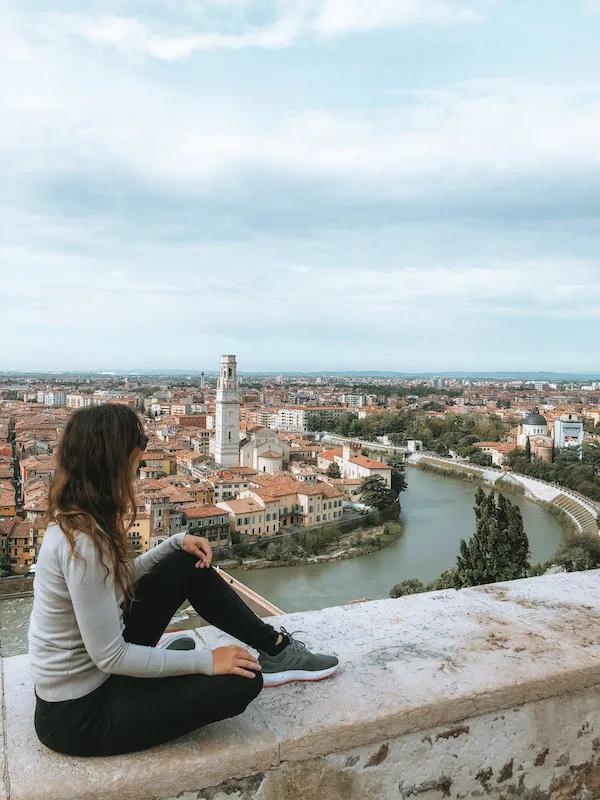 A woman admiring the views of Verona from a viewpoint