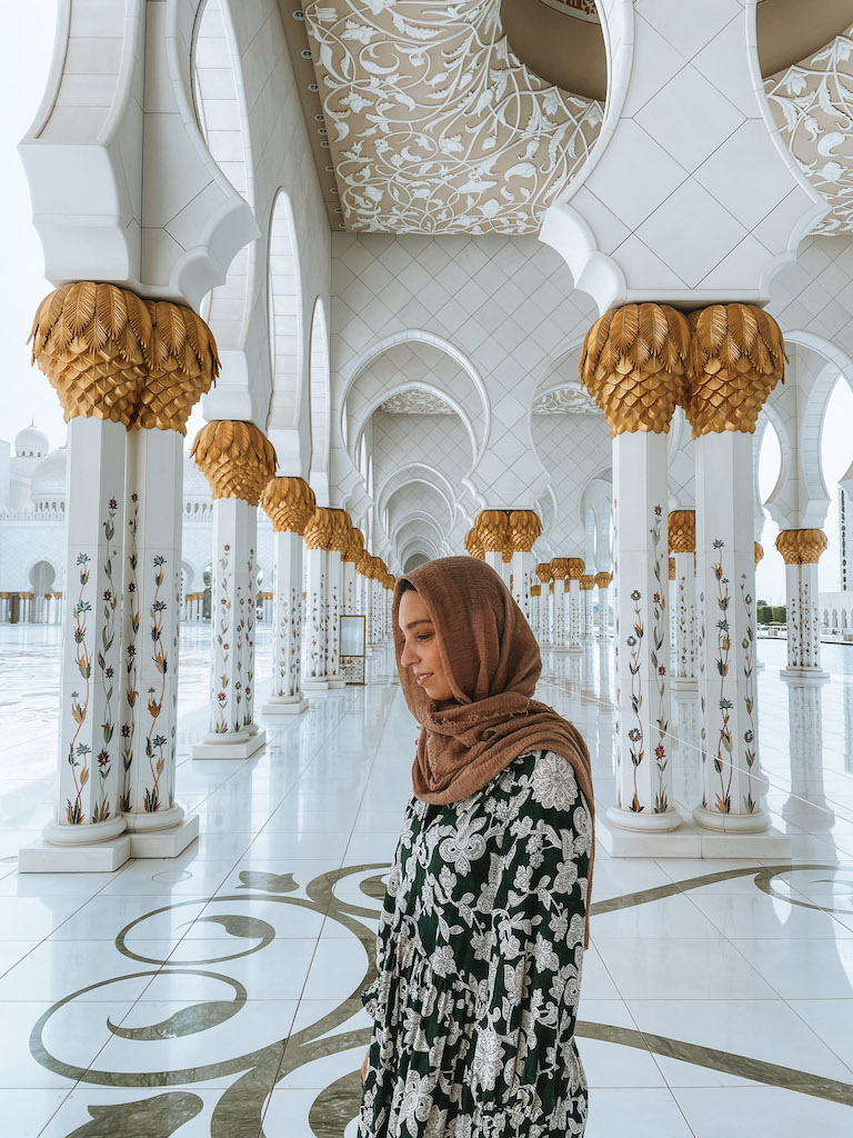 A woman wearing a head scarf in the Grand Zayed Mosque of Abu Dhabi