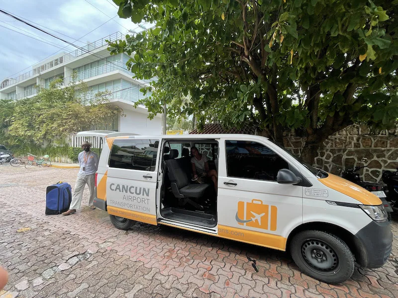 Van with Cancun Airport Transportation logo with door open.