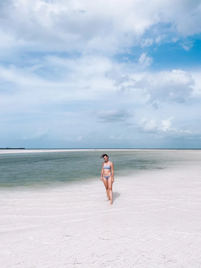 woman standing on a sandbank in Holbox, inserted in a post about how to get from Tulum to Holbox.