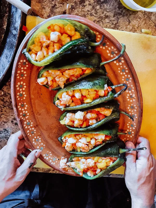 A Mexican dish of stuffed peppers inserted in a  post about Mexican cooking classes