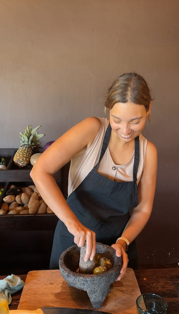 Image of a woman crushing tomatoes 