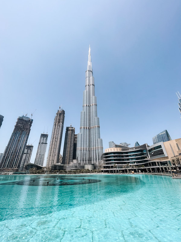 Burj Khalifa, surrounded by other skyscrapers, and a lagoon in the forefront