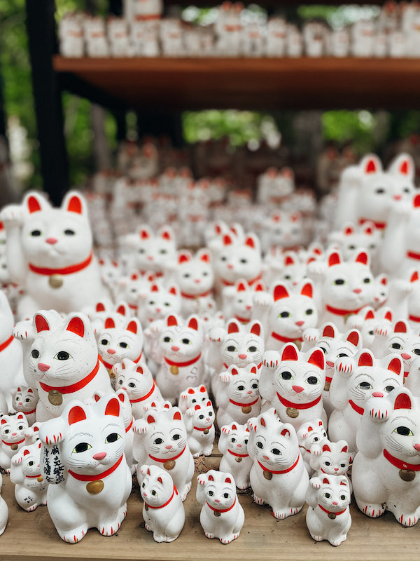 white and red porcelain Japanese cats