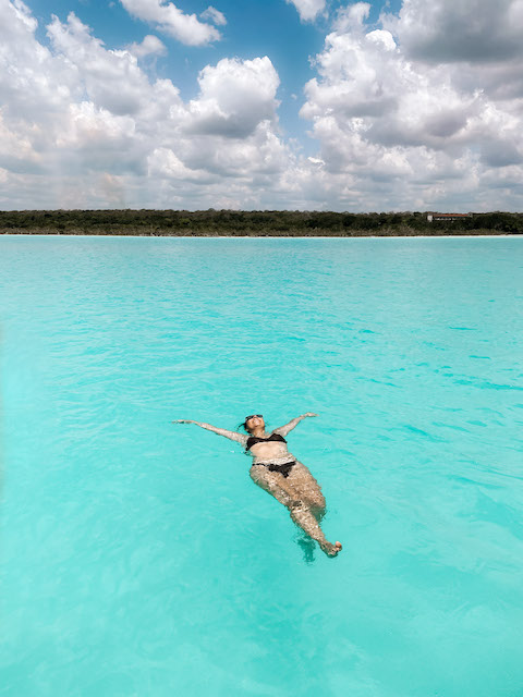 Girl swimming in the turquoise waters of Bacalar Lagoon