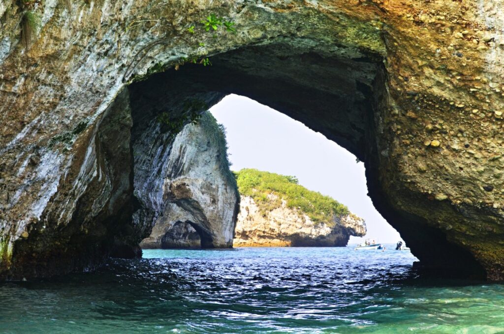 A natural arch formed ina  rock in the sea