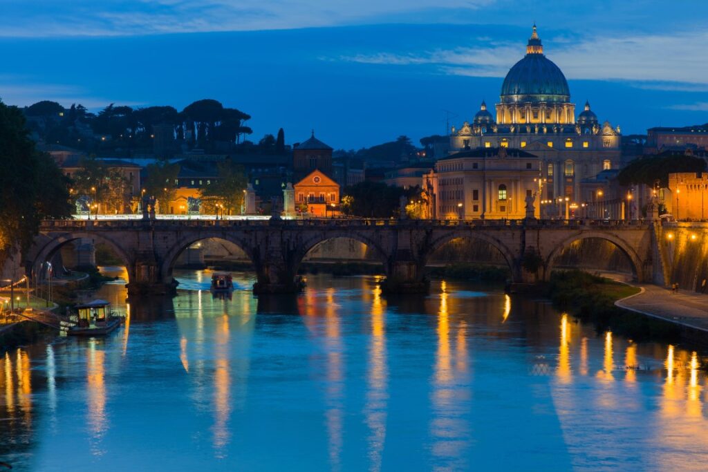 Image of the Tiber River at night, and the Vatican in the background