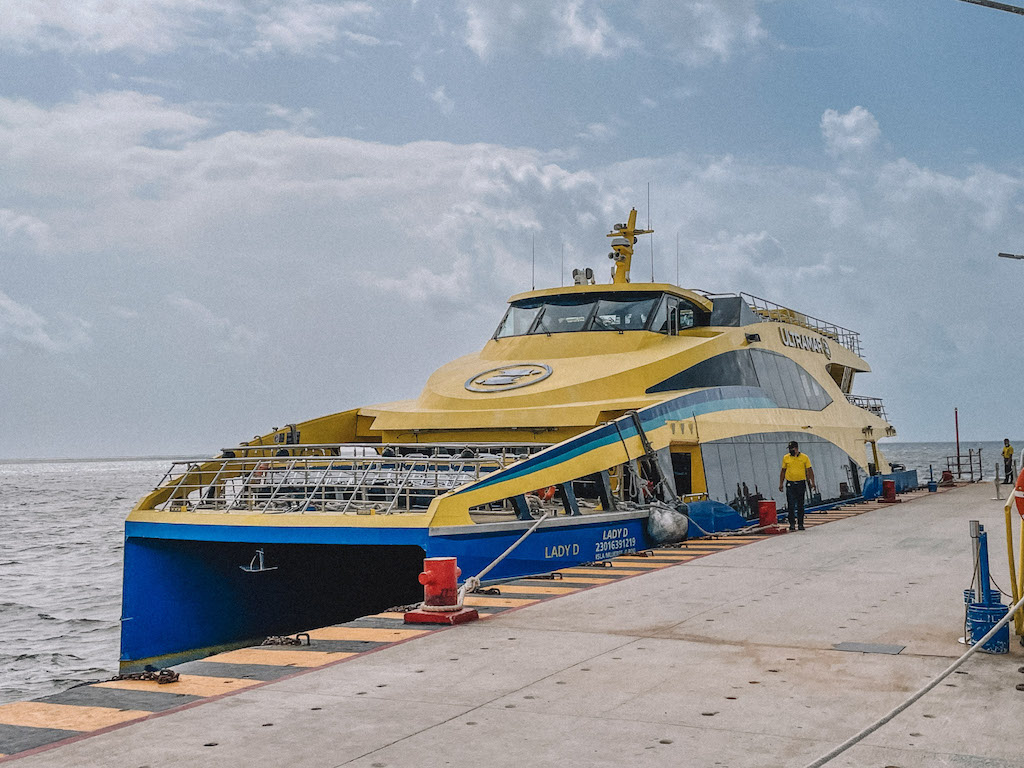 Ultramar yellow and blue catamaran docked in Cancun.