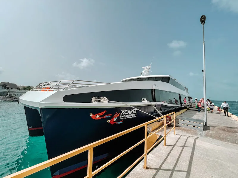 Xcaret Xailing black and white catamaran docked in Cancun.