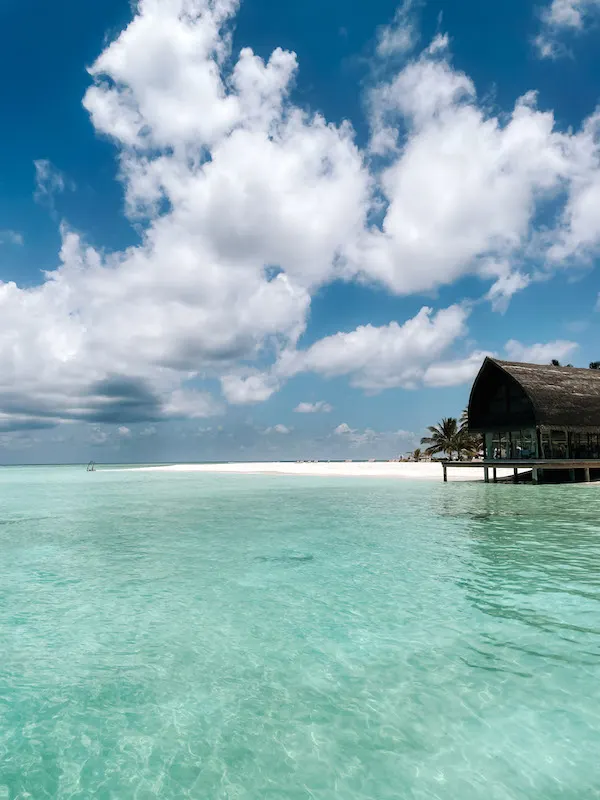 Turquoise sea in the Maldives, and the beach in the background