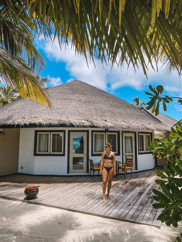 A woman standing on the wooden deck outside a holiday villa