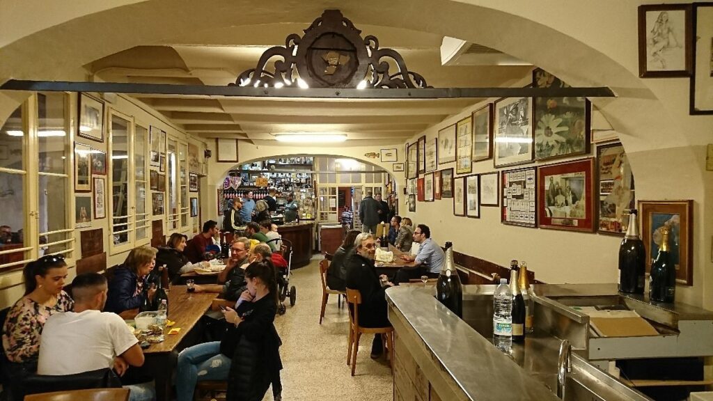 the interior of a restaurant, with people sitting at the tables