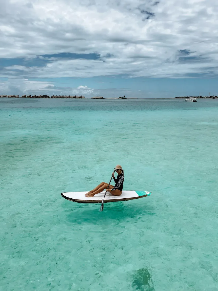 A woman paddleboarding in the sea