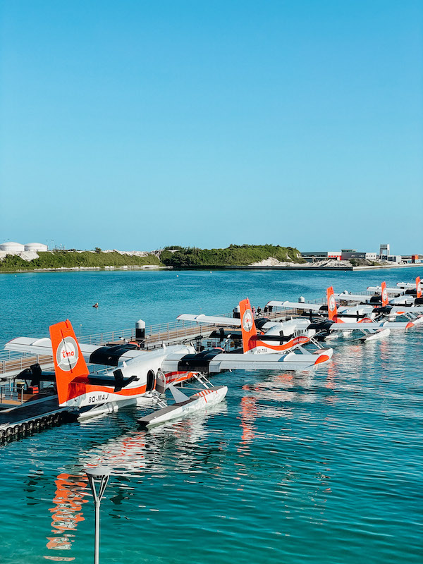 A line of sea planes stationed in blue waters