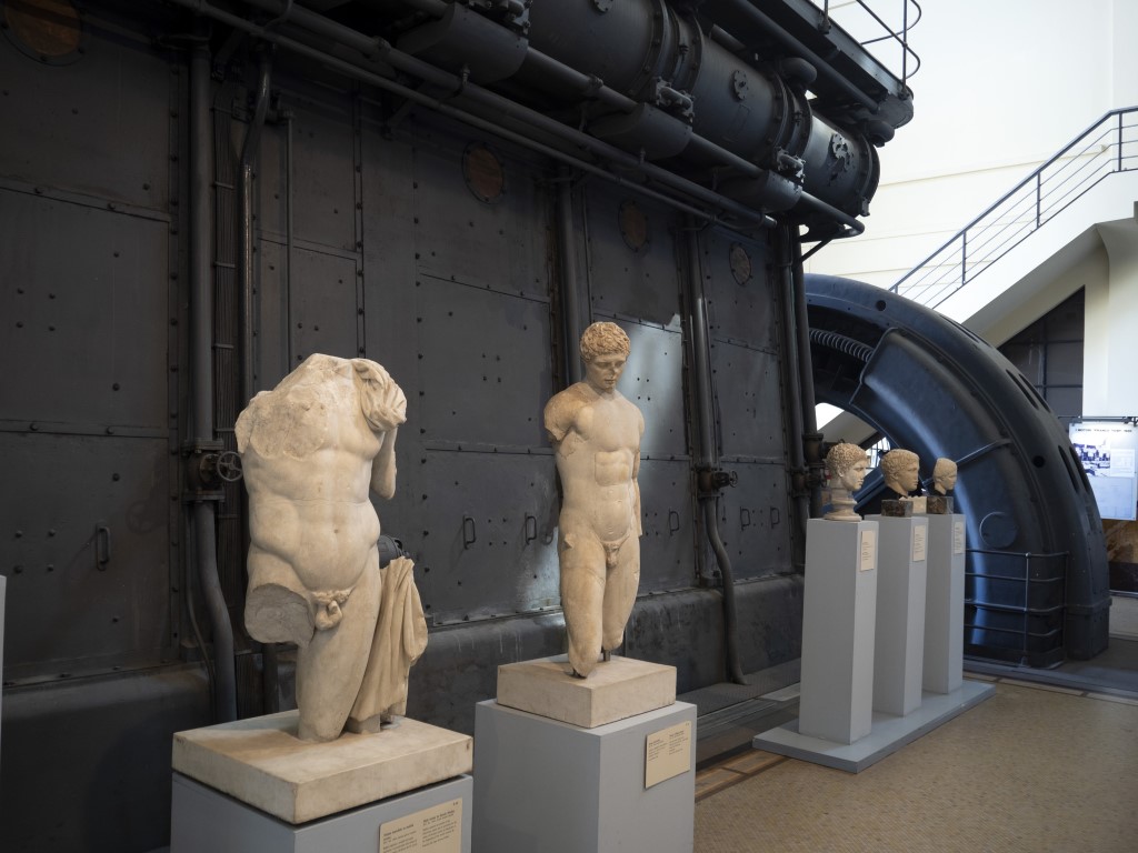 Sculptures of men with an industrial background in the Centrale Montemartini Museum