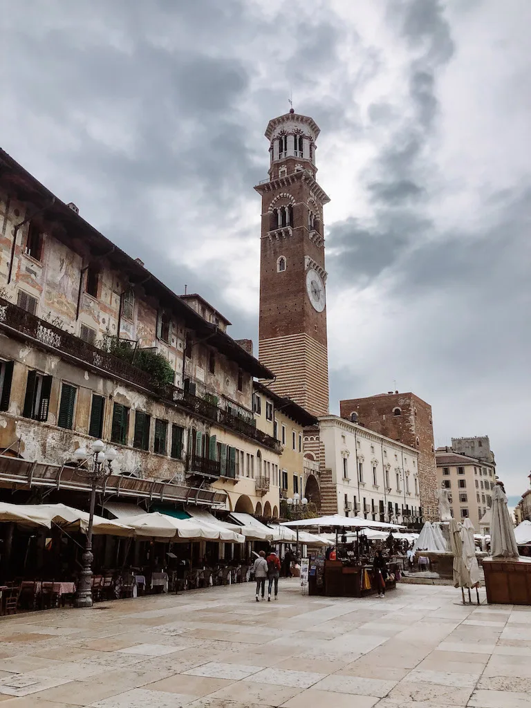 Piazza delle Erbe in Verona, with a clock tower in the background