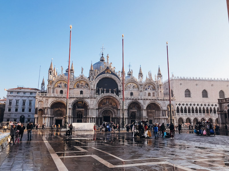 St. Mark's Basilica in Venice, with a crowd standing in front of it 