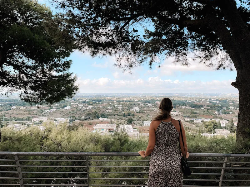 A woman admiring the views of Cisternino from a viewpoint