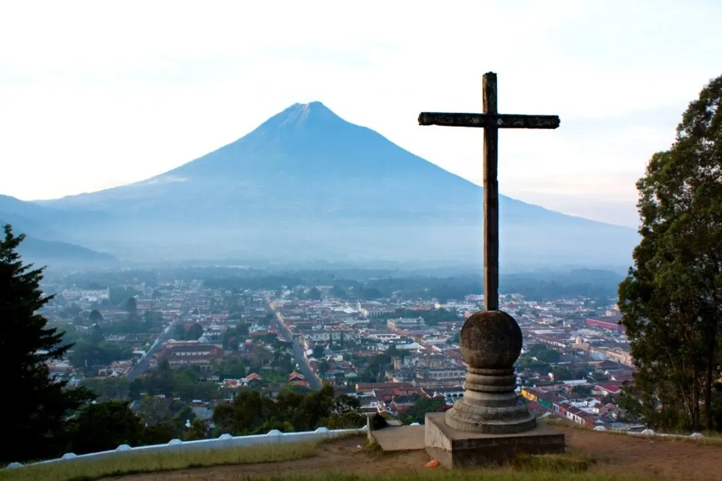 Cerro de la Cruz in Antigua, Guatemala with a volcano in the background