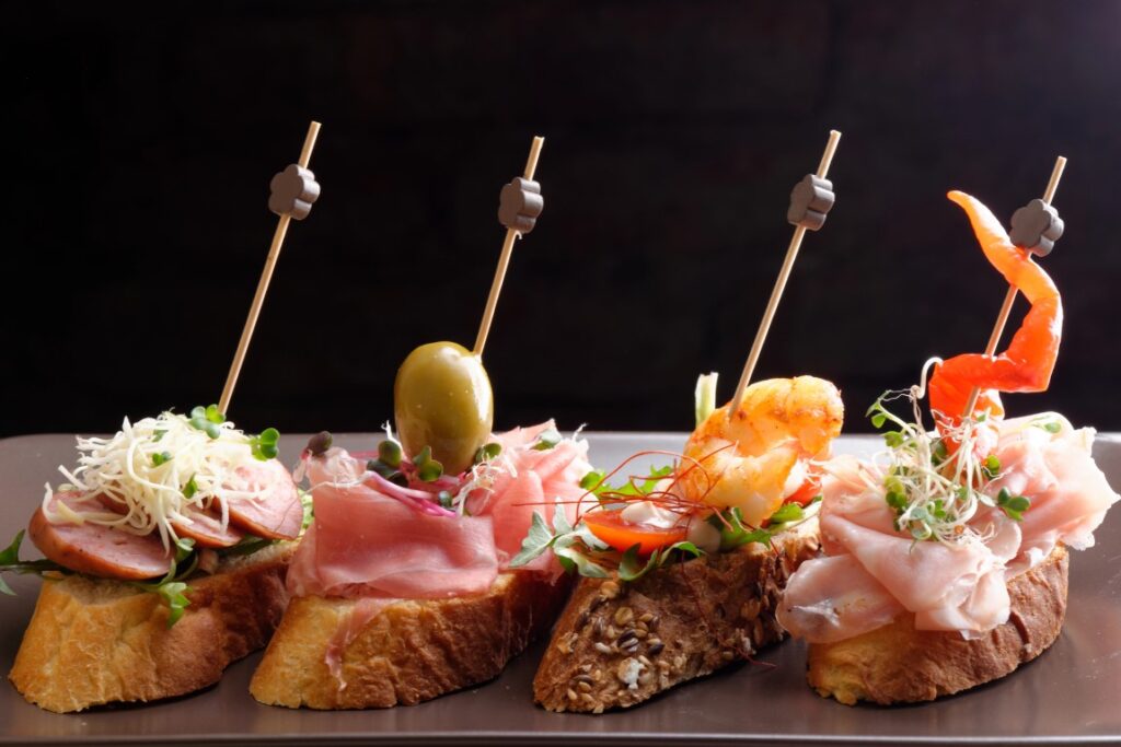 Four Spanish tapas lined in a tray 